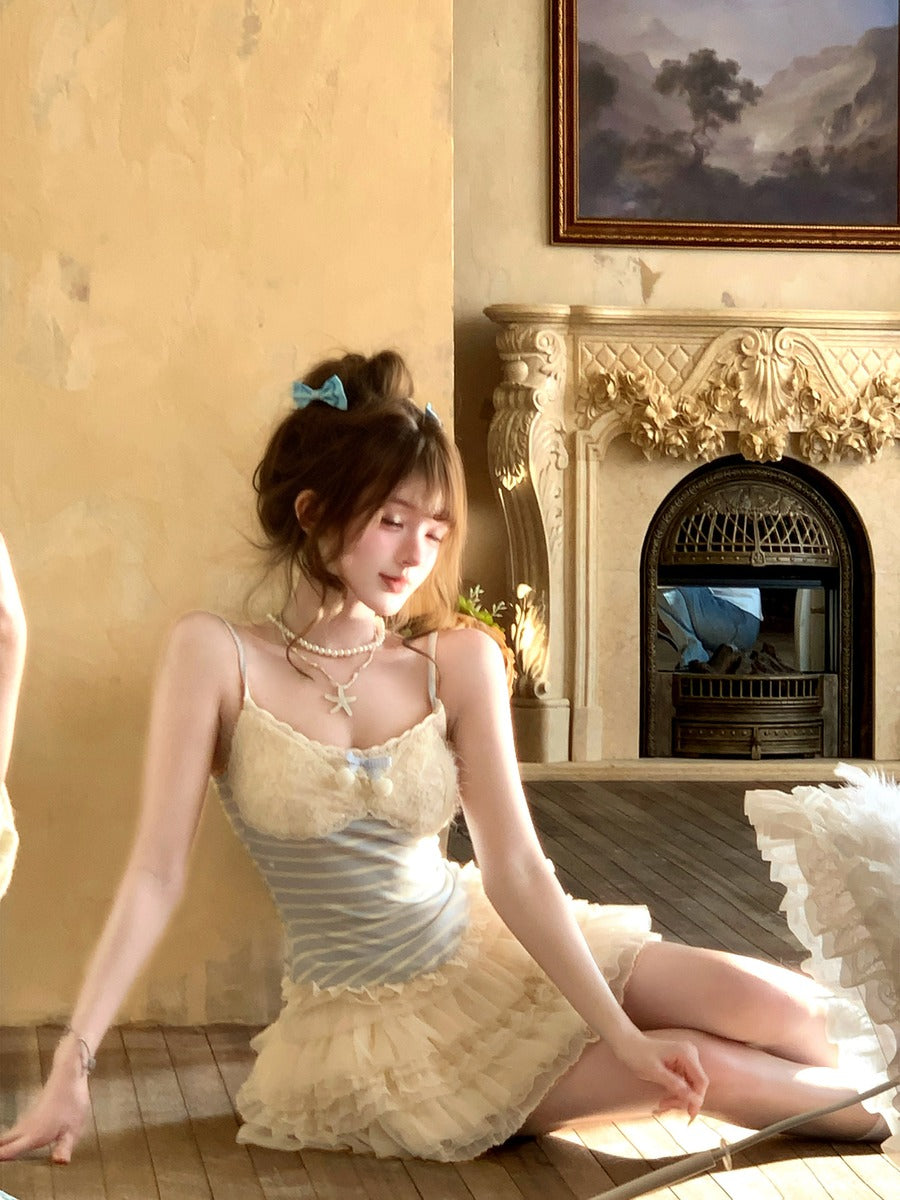 Woman in a light dress sitting in a room with a fireplace and decorative wall.