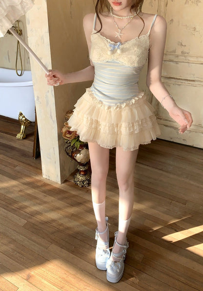 Woman in a pastel-colored dress with a butterfly design standing on a wooden floor.