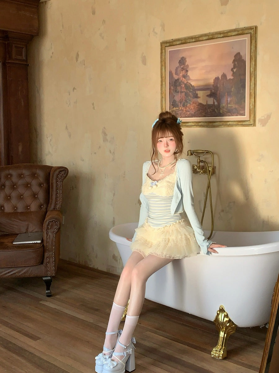 Woman sitting on a white bathtub in a room with a painting on the wall.