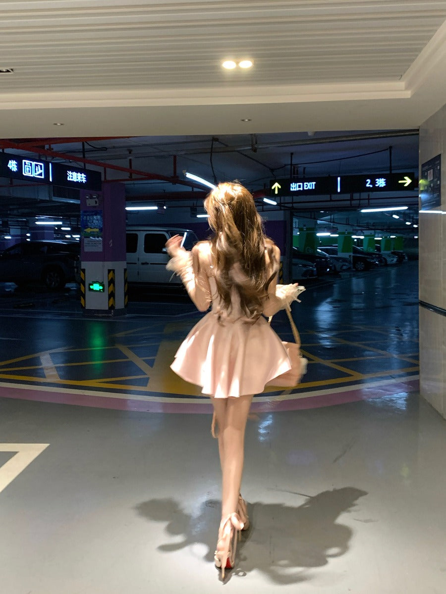 Woman in a pink dress standing in a parking garage.