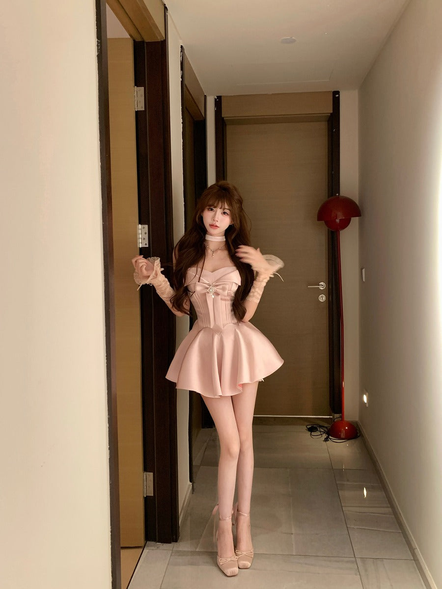 Woman in a pink dress standing in a hallway