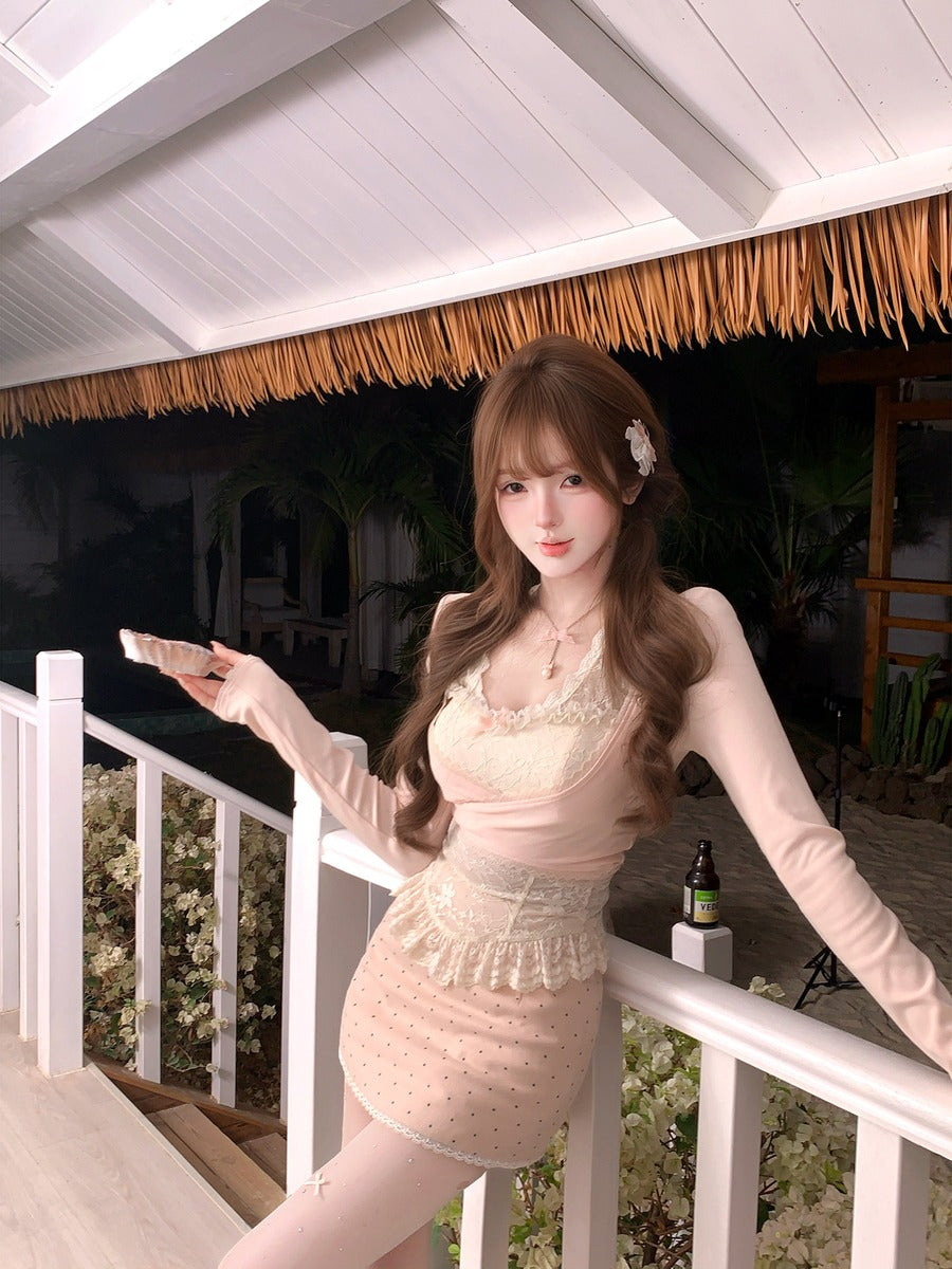 Woman in a pink dress standing on a balcony with a thatched roof background