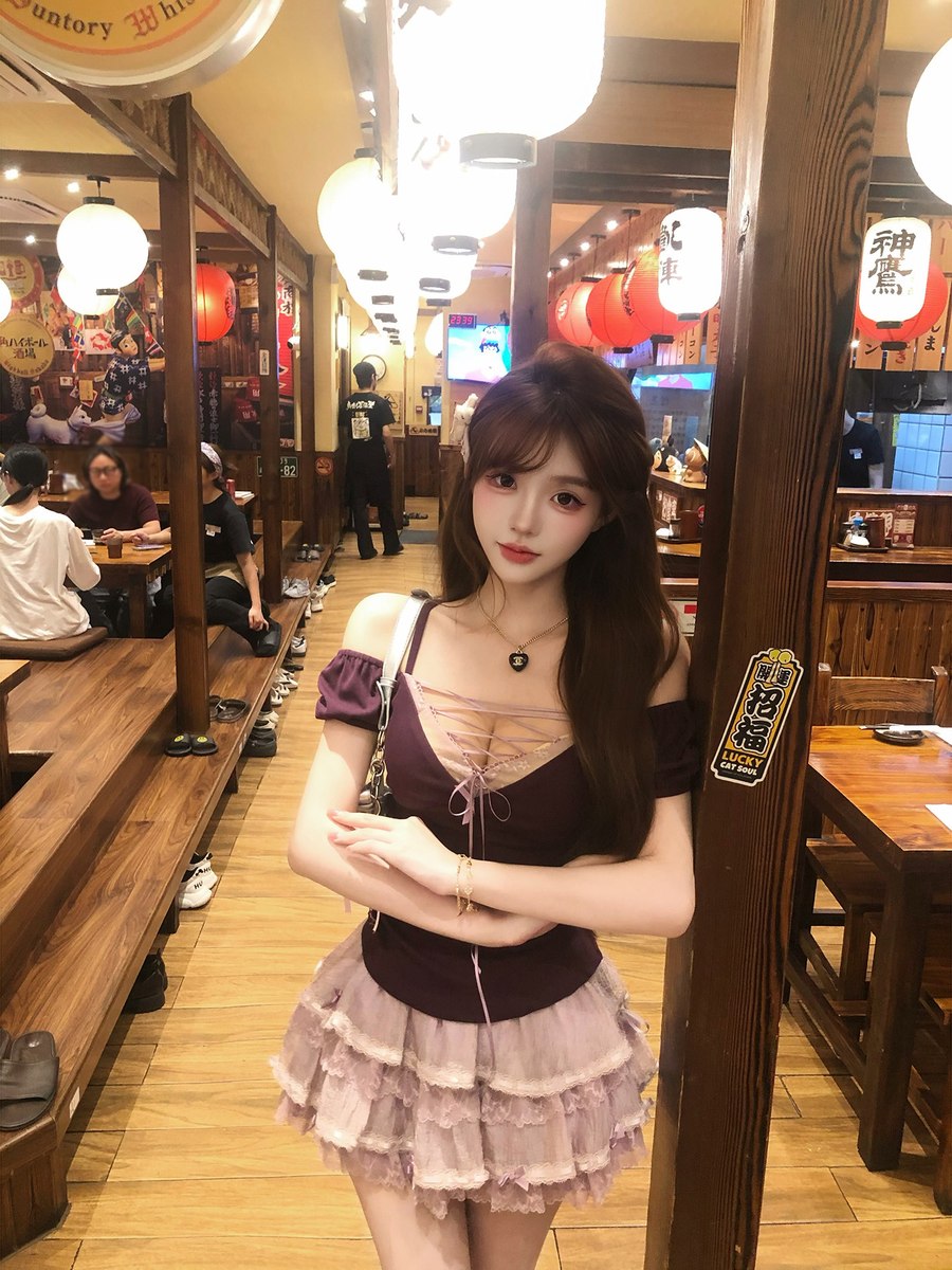 Woman in a restaurant setting with wooden interior and hanging lights
