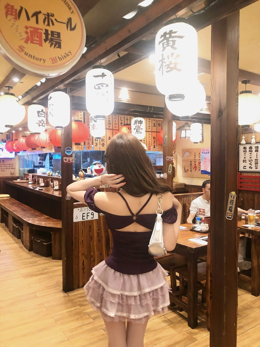 Woman in a restaurant with wooden interior and hanging lanterns