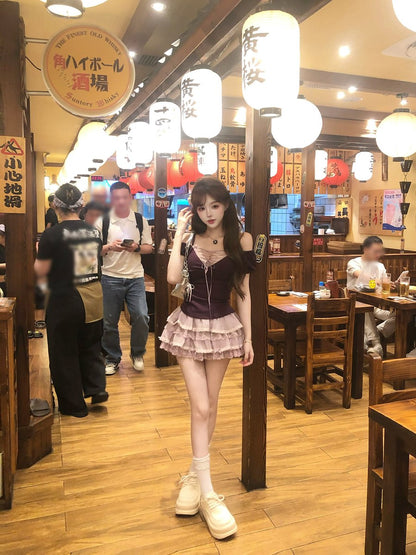 Woman posing in a restaurant with wooden floors and tables, surrounded by people.