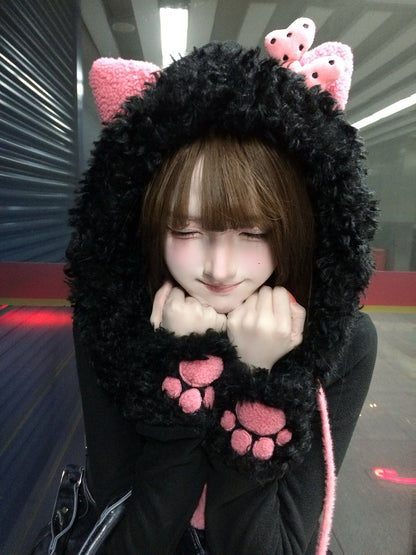 Person wearing a black and pink cat-themed hoodie with paw patterns.
