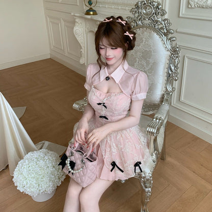 Woman in a pink dress sitting on an ornate chair in a decorated room.