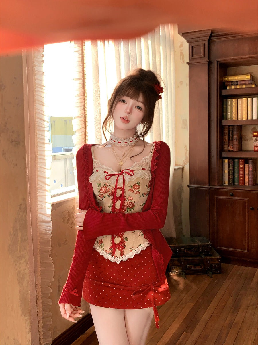 Woman in a red outfit standing in a room with a bookshelf and window.