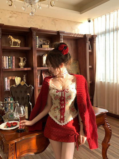 Woman in a red outfit with floral details in a room with wooden furniture and decor.