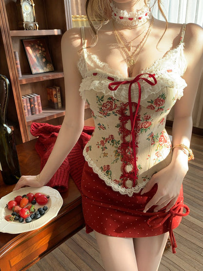 Person wearing a floral corset and red skirt in a room with a bookshelf.