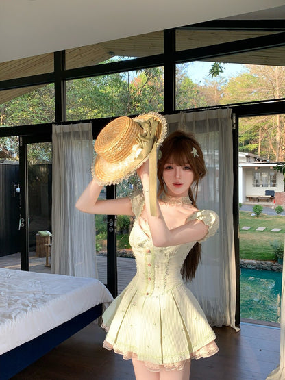 Woman in a light dress holding a large hat indoors with a view of trees outside.
