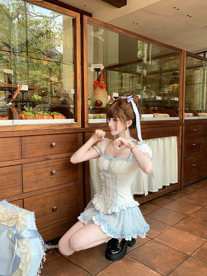 Person in a maid outfit posing in a restaurant kitchen.