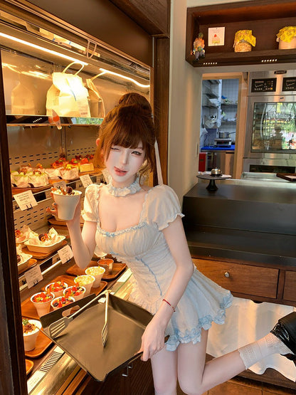 Person in a kitchen holding a tray with food