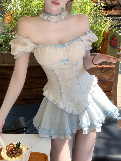 Person wearing a light-colored, ruffled dress with a blurred background