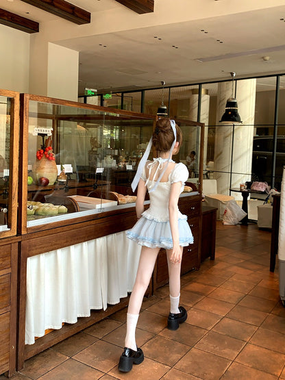 Young girl in a ballet outfit standing in a restaurant.