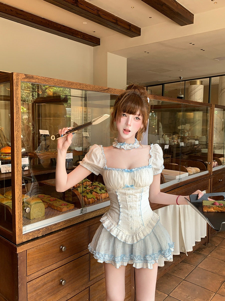 Person in a maid outfit holding a spatula in a restaurant setting