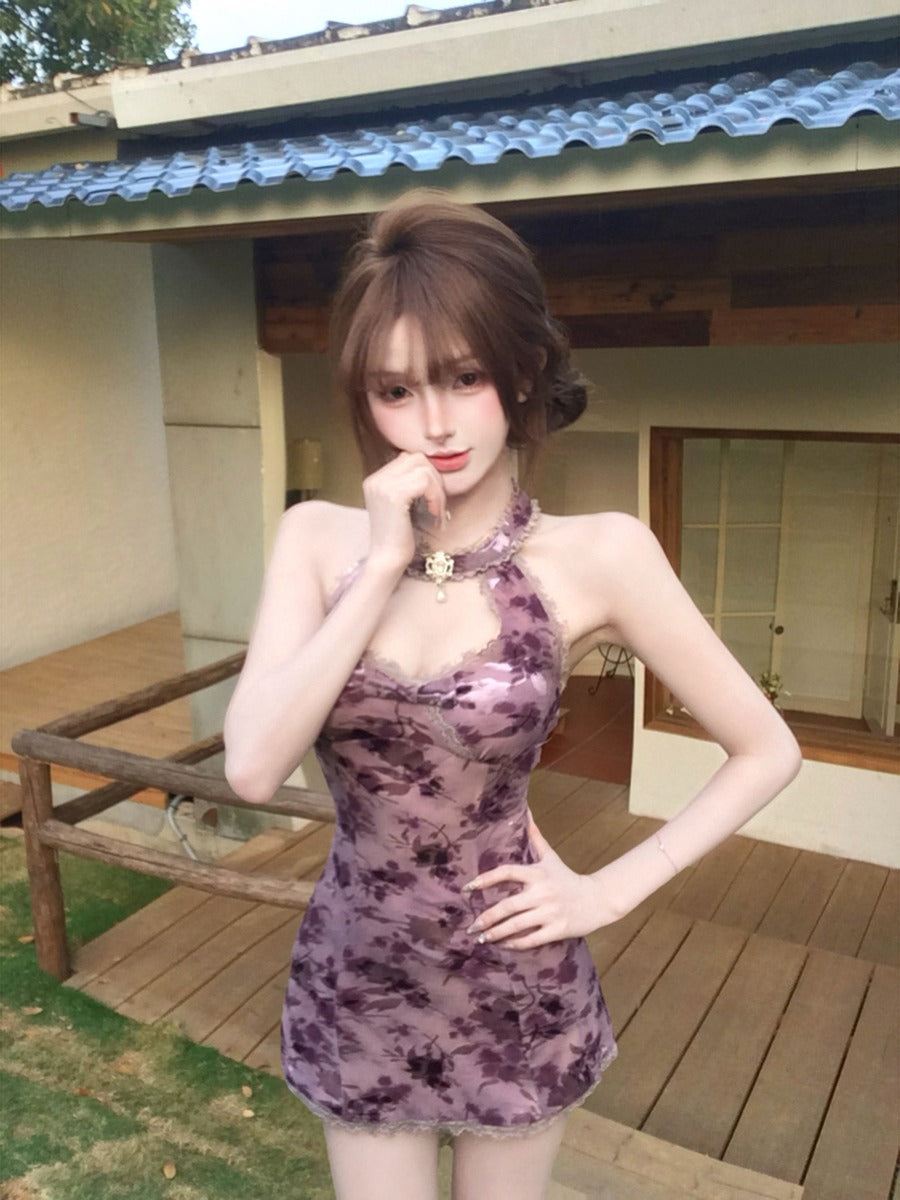 Woman in a purple dress standing outdoors on a wooden deck.