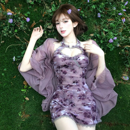 Woman in a purple dress lying on grass with flowers