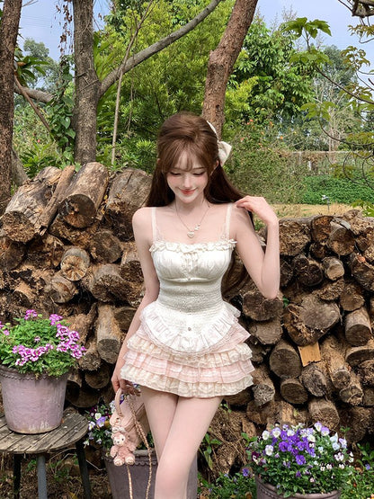 Woman in a white dress standing in front of stacked logs with flowers around