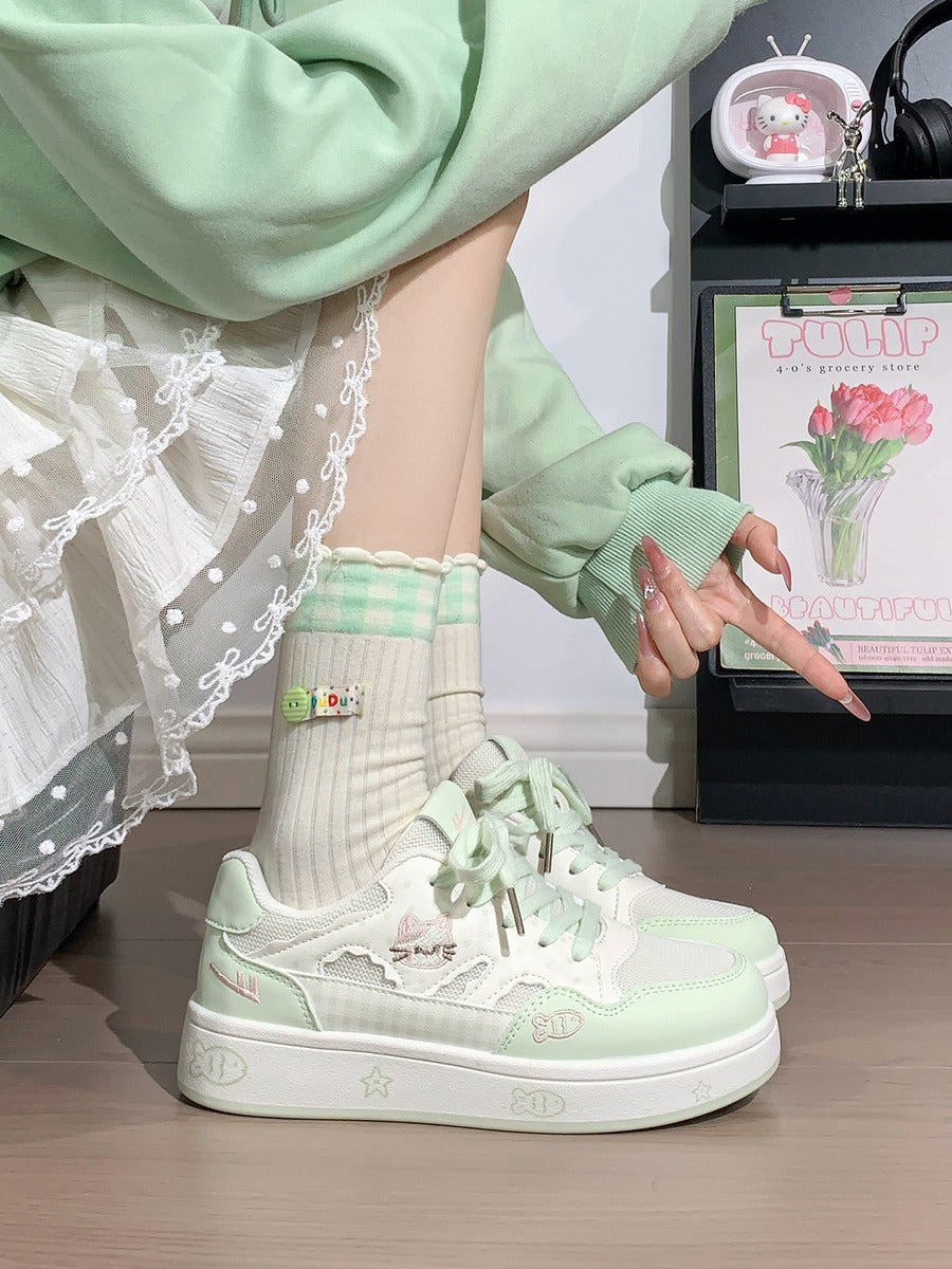 Person wearing light green sneakers and matching socks, standing indoors.