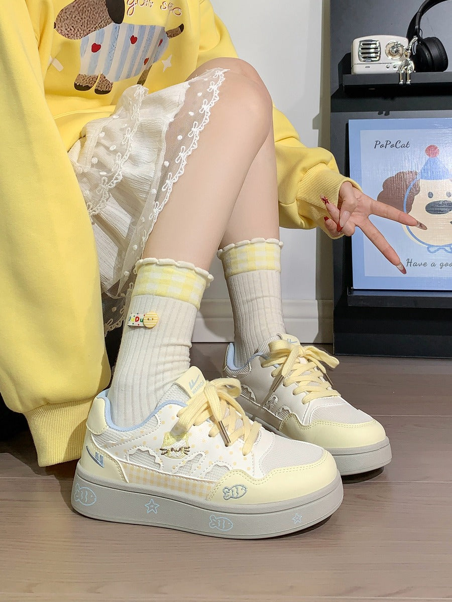 Person wearing yellow sneakers and socks sitting on a chair with a screen displaying a cartoon character in the background.