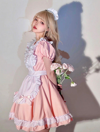 Person wearing a pink maid outfit holding flowers against a plain background