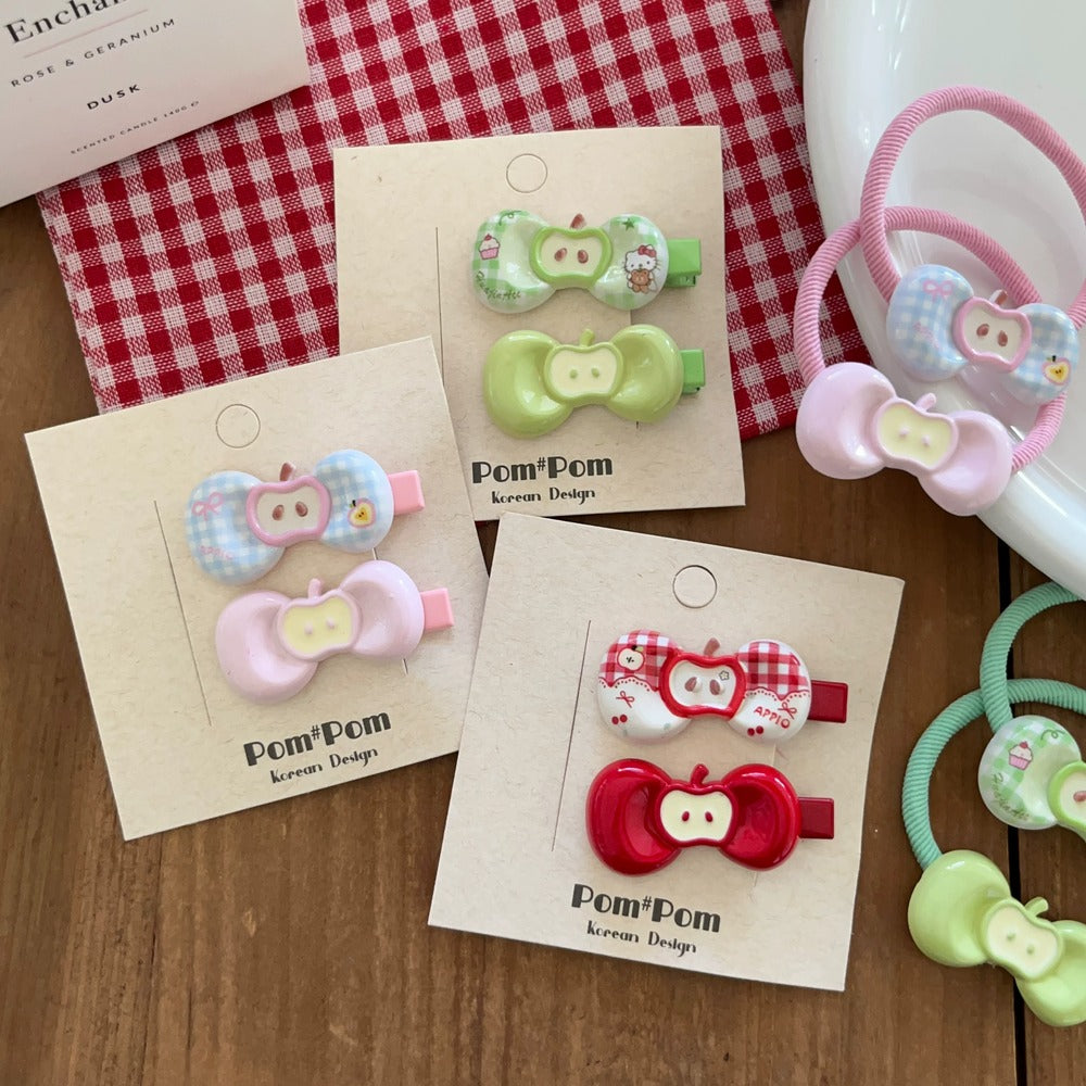 Set of colorful hair clips on display with 'Pom Pom' branding.