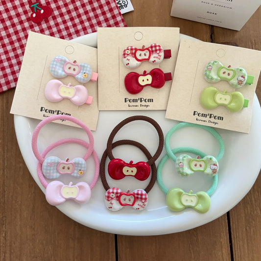Set of colorful hair accessories with packaging on a white plate