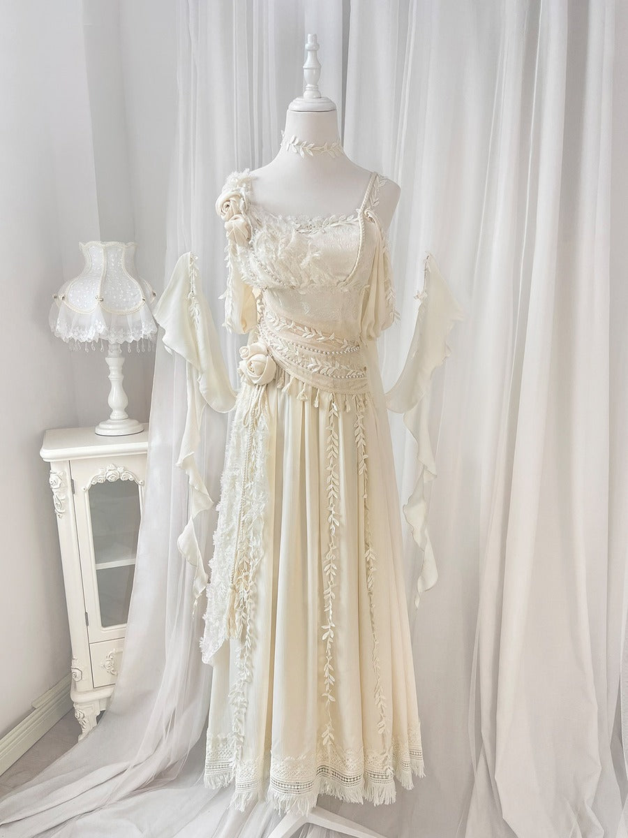 Elegant lace dress on a mannequin against a white curtain backdrop