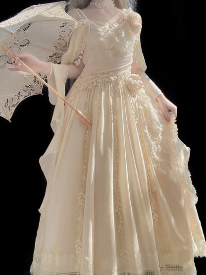 A cream-colored Victorian-style Lolita dress with intricate lace embroidery, sheer sleeves, and a matching lace parasol, shown on a model against a solid black background.