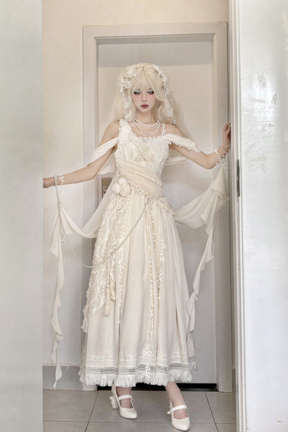 A person wearing a long cream/off-white Lolita-style dress with lace, ruffles, and sheer draped fabric, standing in a doorway indoors.