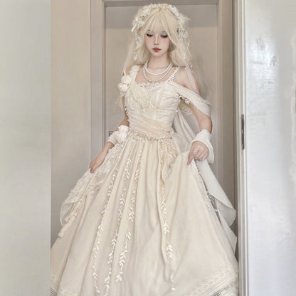 A woman modeling a voluminous off-white Lolita-style dress with lace embroidery, a matching headpiece, and white shoes, standing in a doorway.