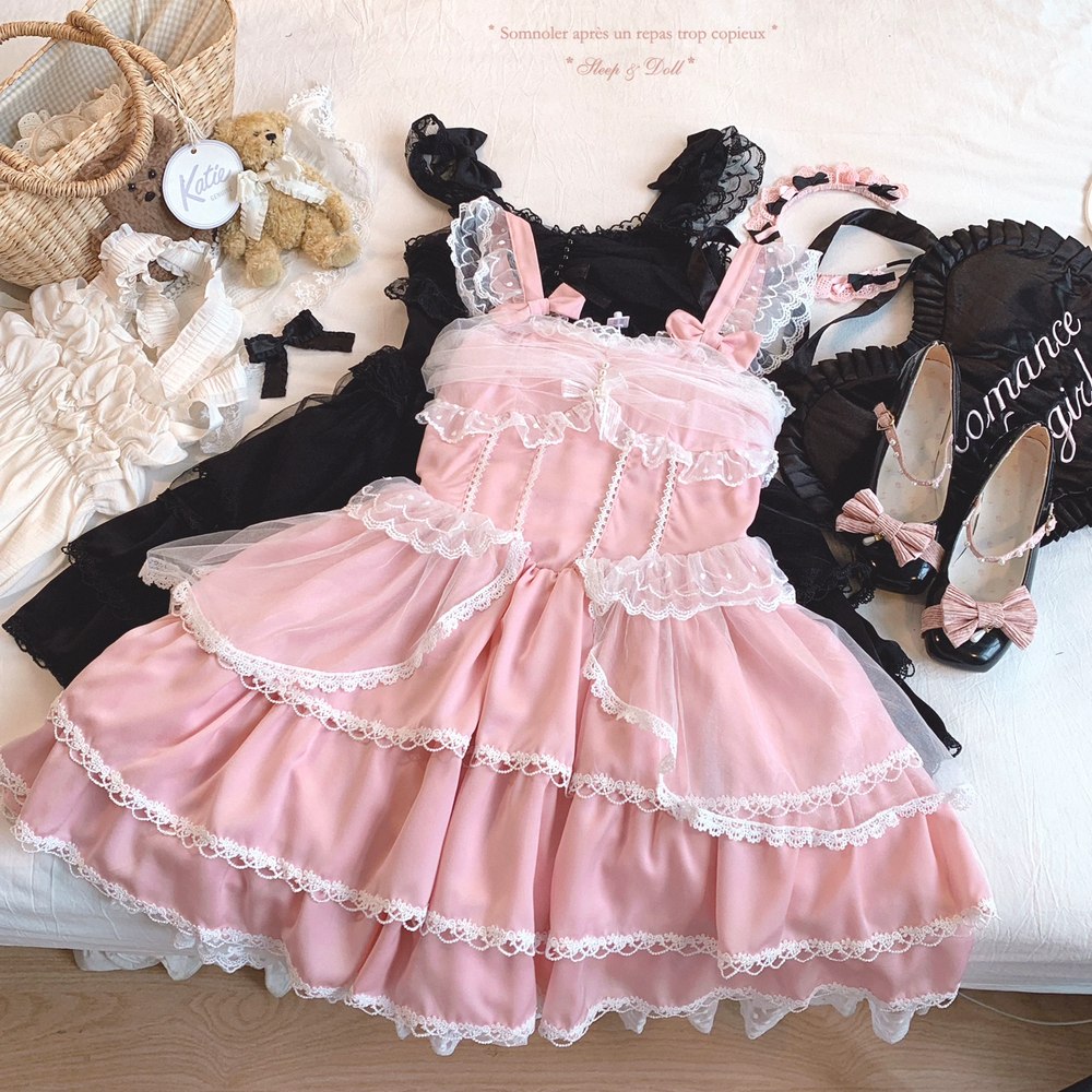 Pink lace dress with black and white accessories on a light background