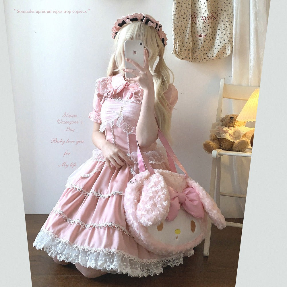 Person wearing a pink dress with a fluffy bag, taking a mirror selfie.