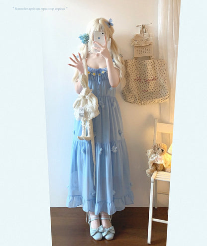 Person wearing a blue dress with white accents in a room.