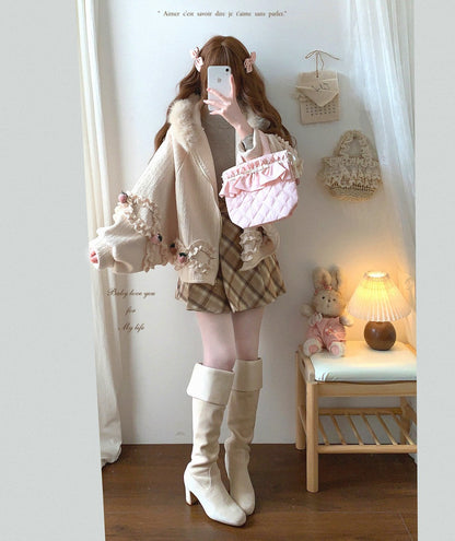 Person wearing a cute outfit with a plaid skirt, white knee-high boots, and a pink top in a room.