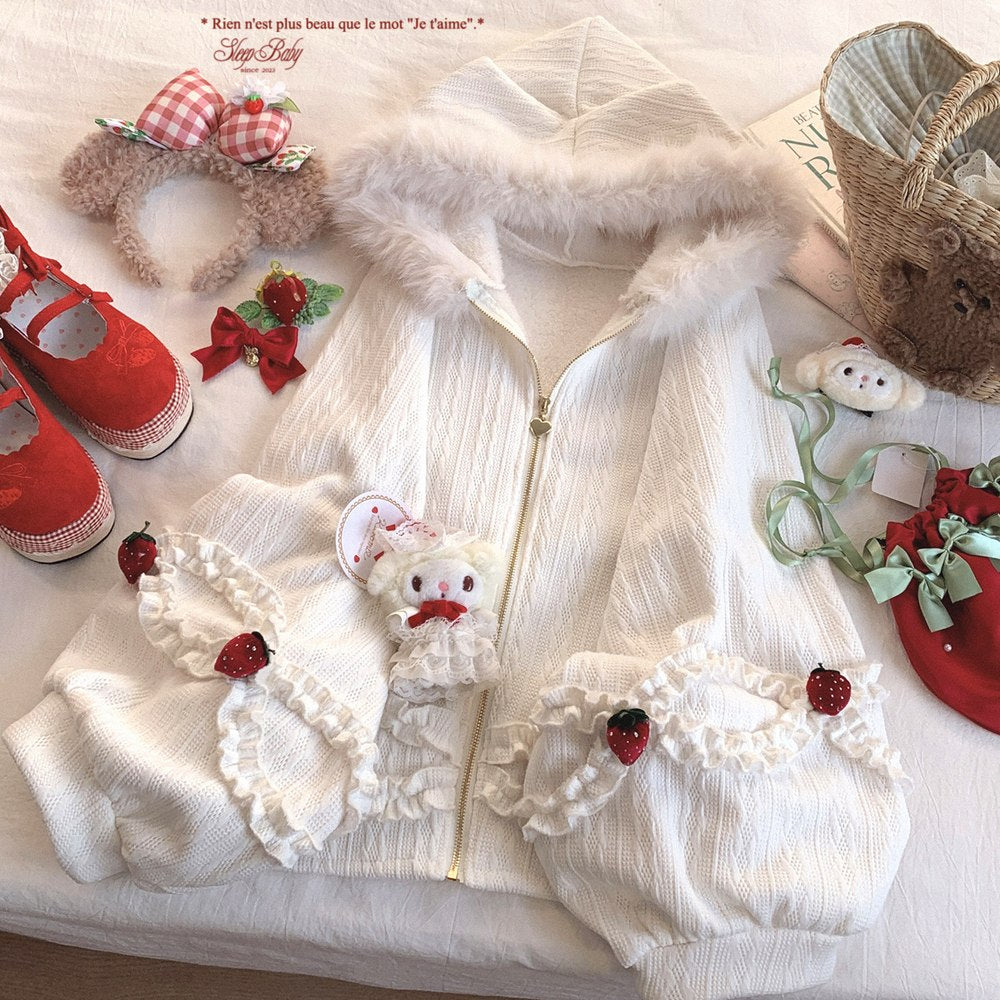White strawberry jacket outfit with red and green accents on a white surface