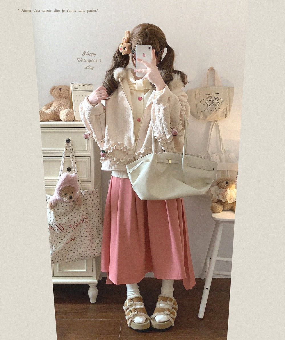 Person wearing a pink skirt and white jacket in a room with stuffed animals and a backpack.