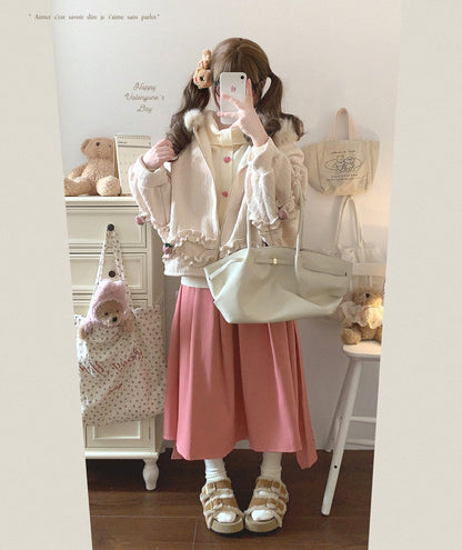 Person wearing a pink skirt and white jacket in a room with stuffed animals and a backpack.