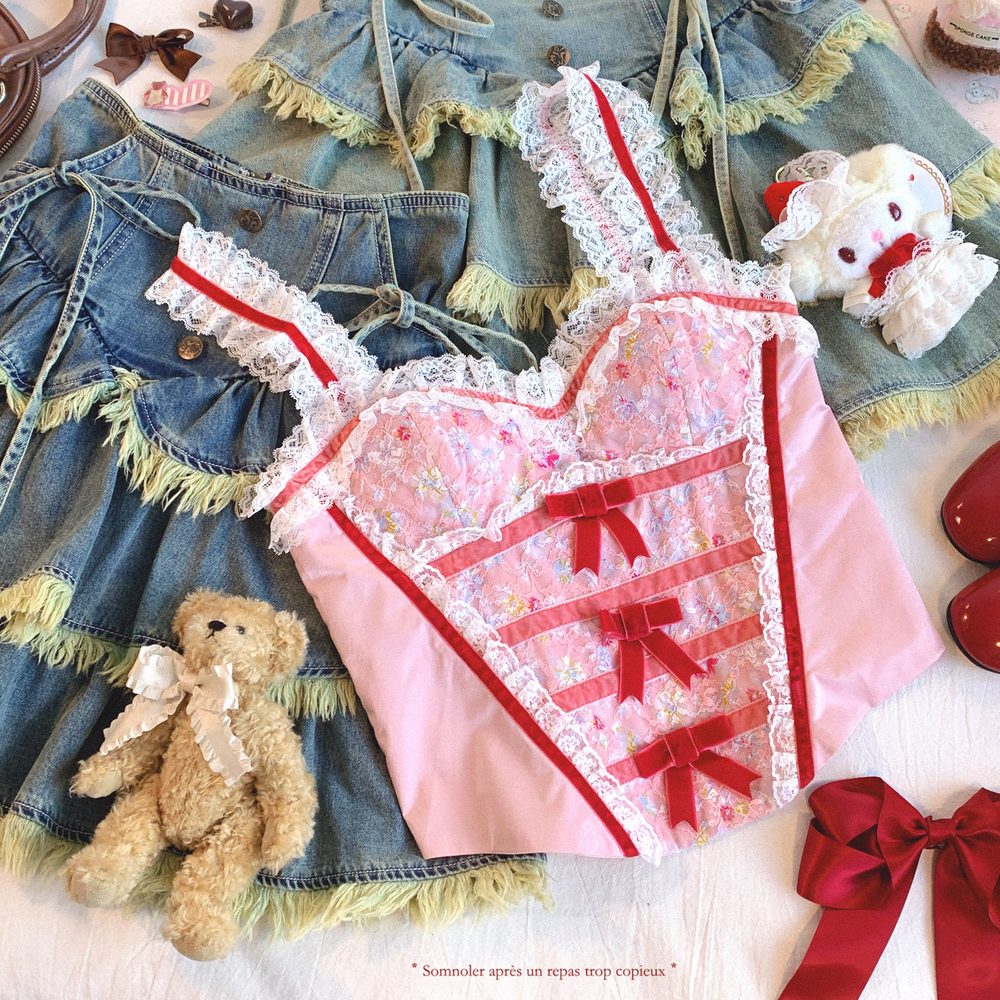 Pink lace top with red ribbons on a denim skirt with teddy bear and bows.