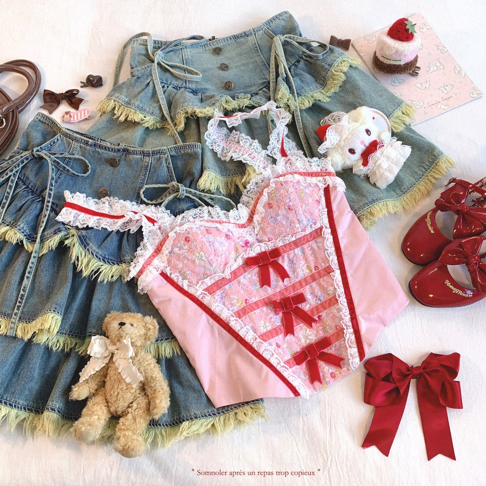 Women clothing and accessories including a denim dress, pink dress with red ribbons, teddy bear, and shoes on a white background.