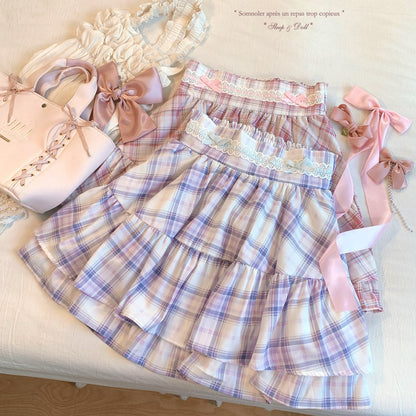 Plaid dress with pink ribbons on a beige surface
