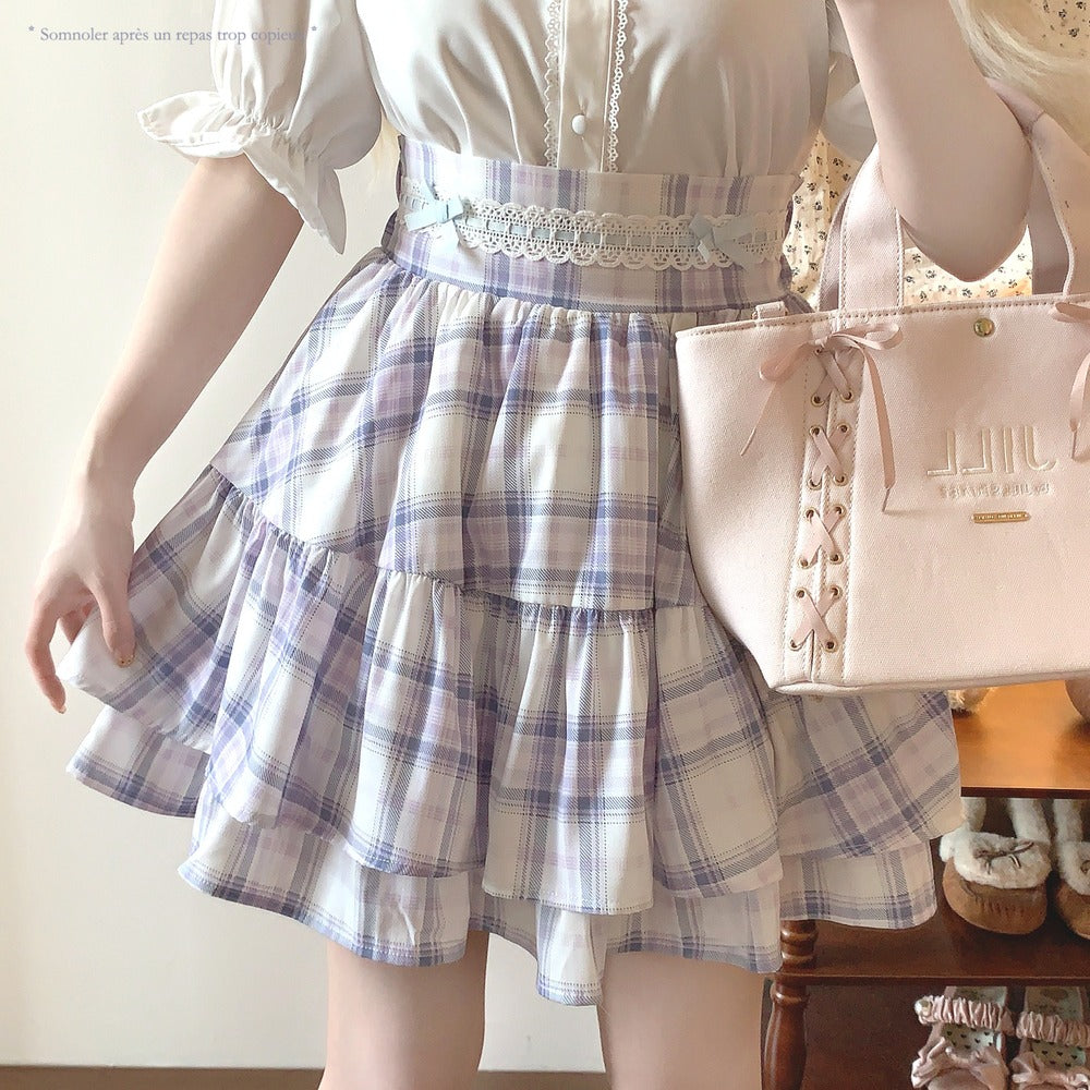 Person wearing a white blouse with a plaid skirt and holding a pink handbag.