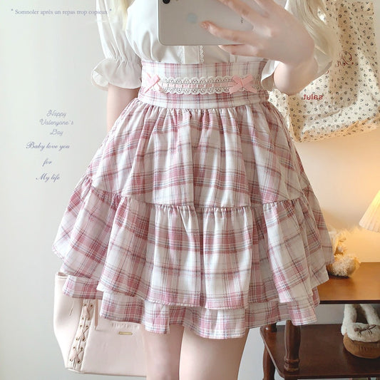 Person wearing a plaid dress with a white background