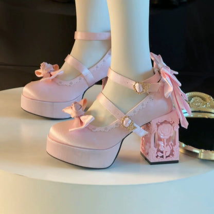 Pink platform shoes with floral details worn by a person, on a neutral background.