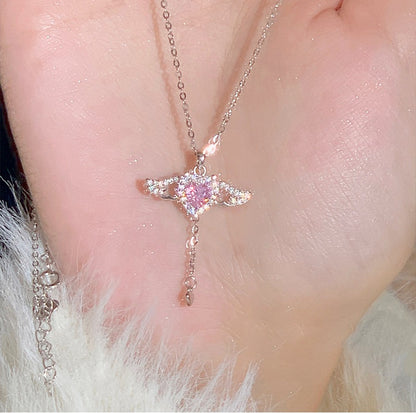 Necklace with a star-shaped pendant featuring pink gemstones on a person's neck.