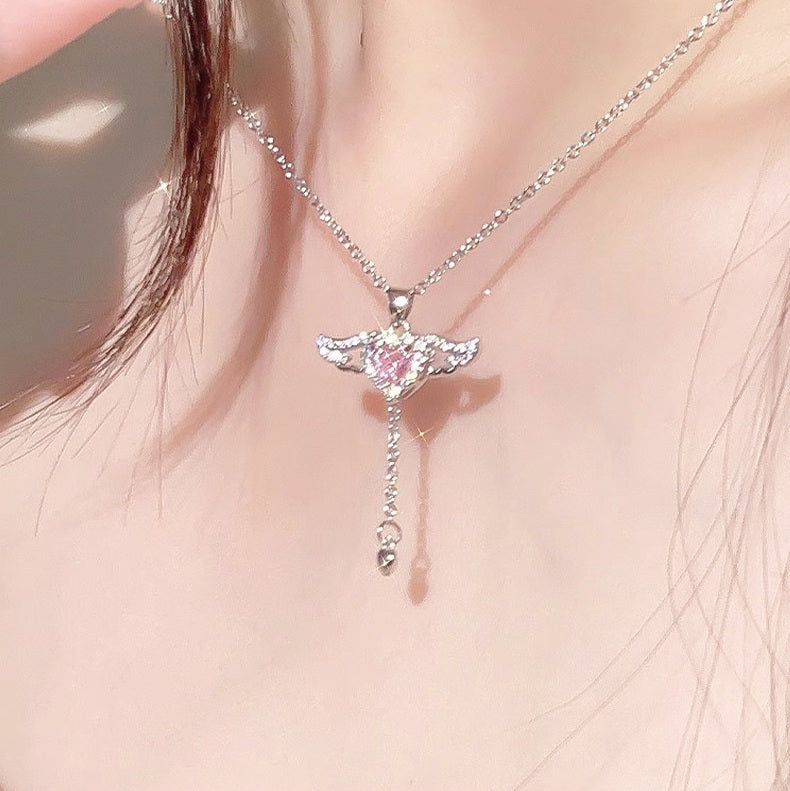 Necklace with a heart-shaped pendant worn by a person