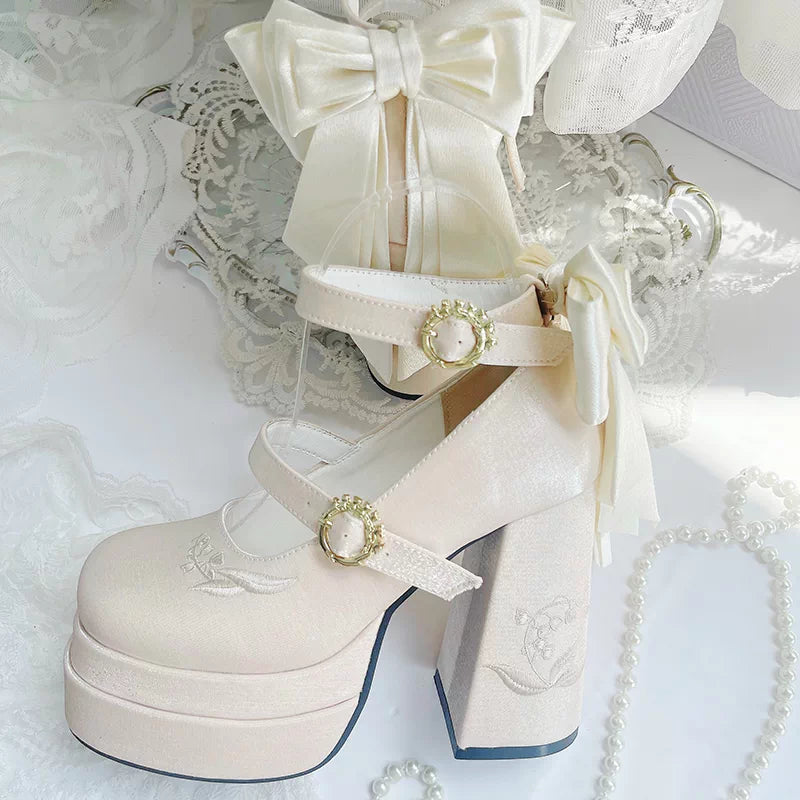 White platform shoes with decorative bows and ribbons on a lace background