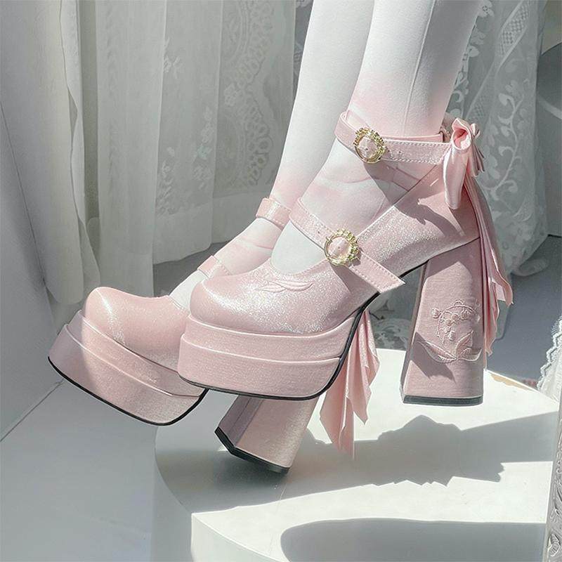 Pink platform boots with decorative ribbons and flowers on a white background