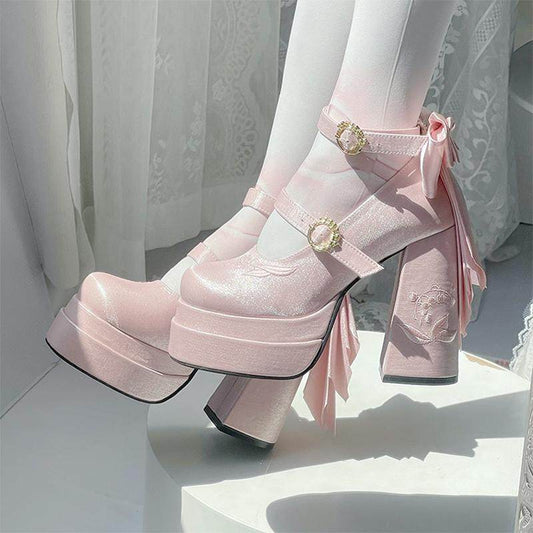 Pink platform boots with decorative ribbons and flowers on a white background